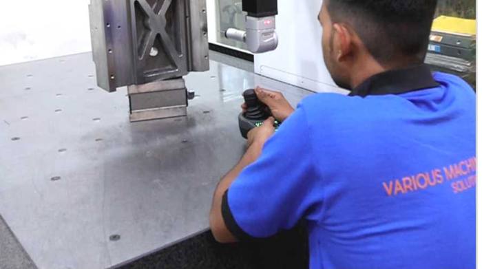 VMSL inspector measuring a machined part on the CMM